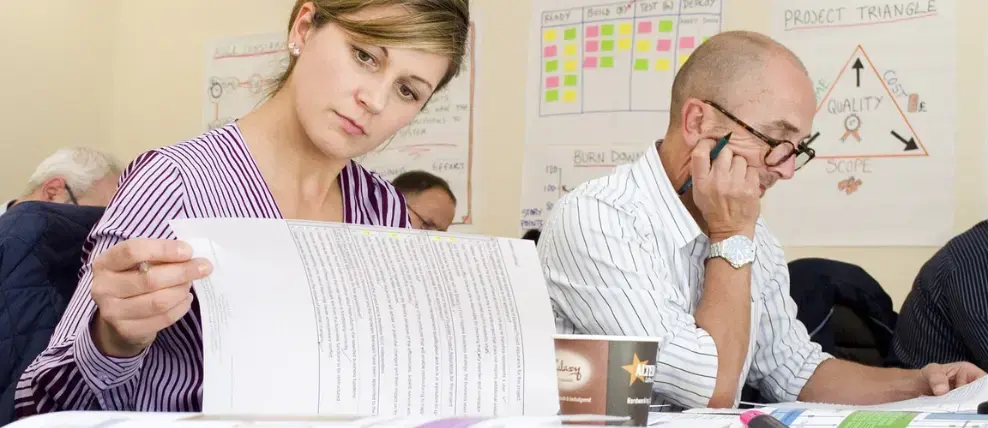 Two people working with project management